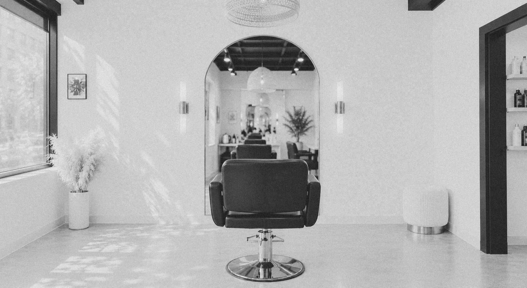 a quiet salon suite: a styling chair, mirror and warm light — the kind of one-chair space kade does the books for